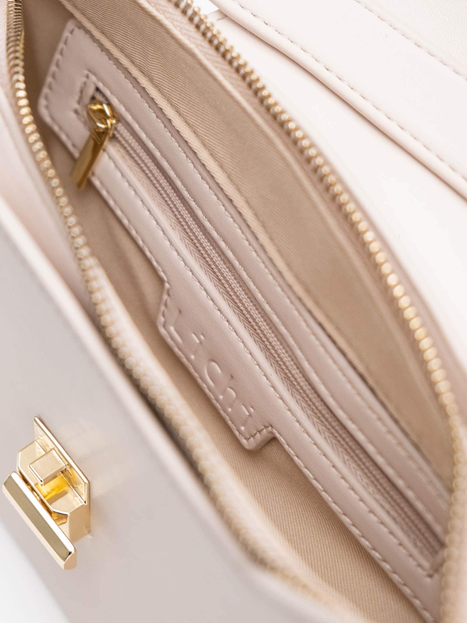 Trapeze-shaped bag with wide shoulder strap