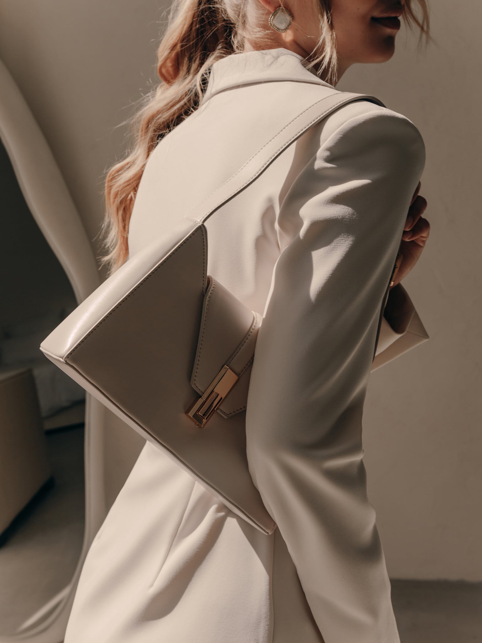 Trapeze-shaped bag with wide shoulder strap