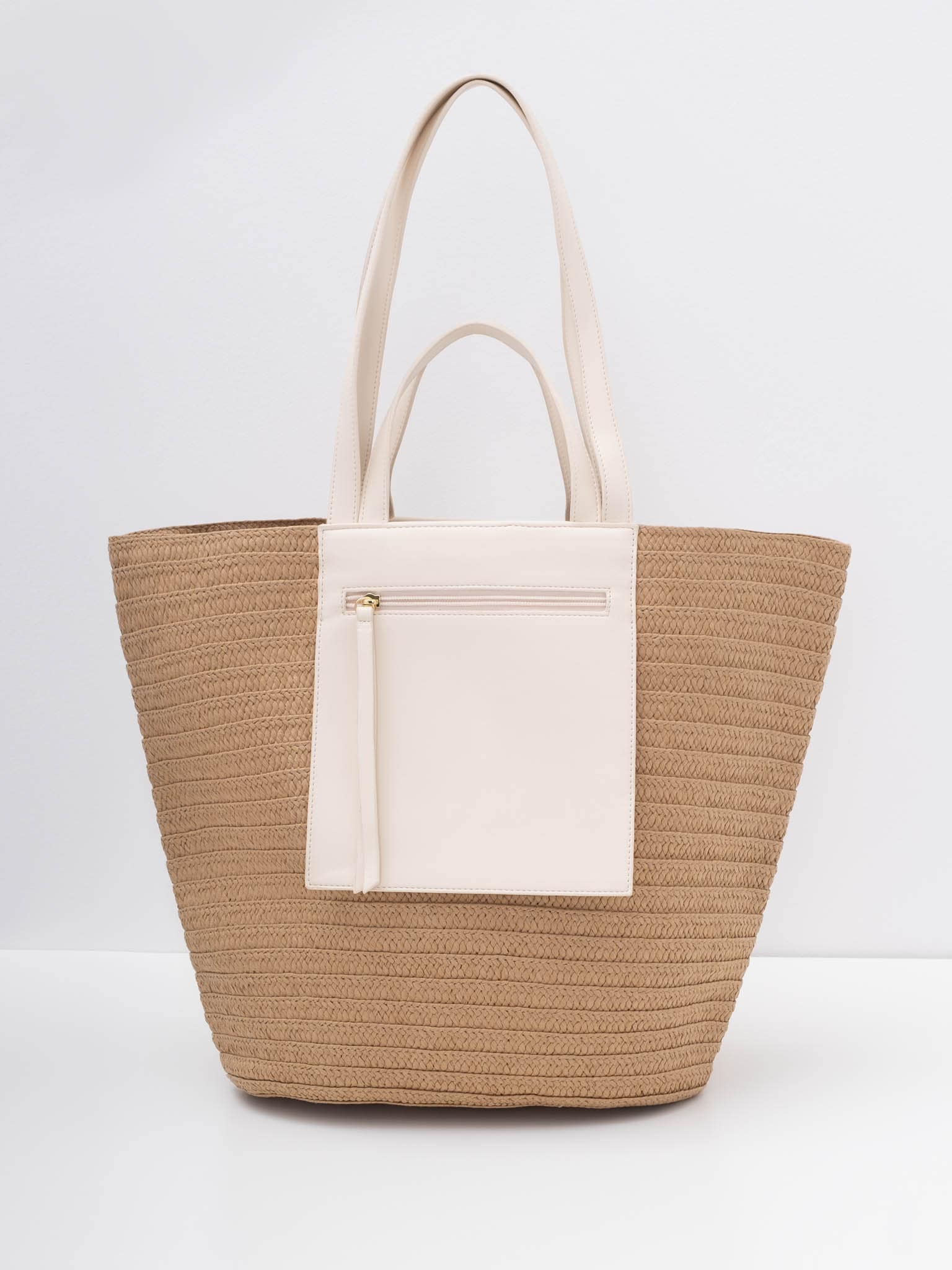 Soft-shaped wicker bag with eco-leather inserts