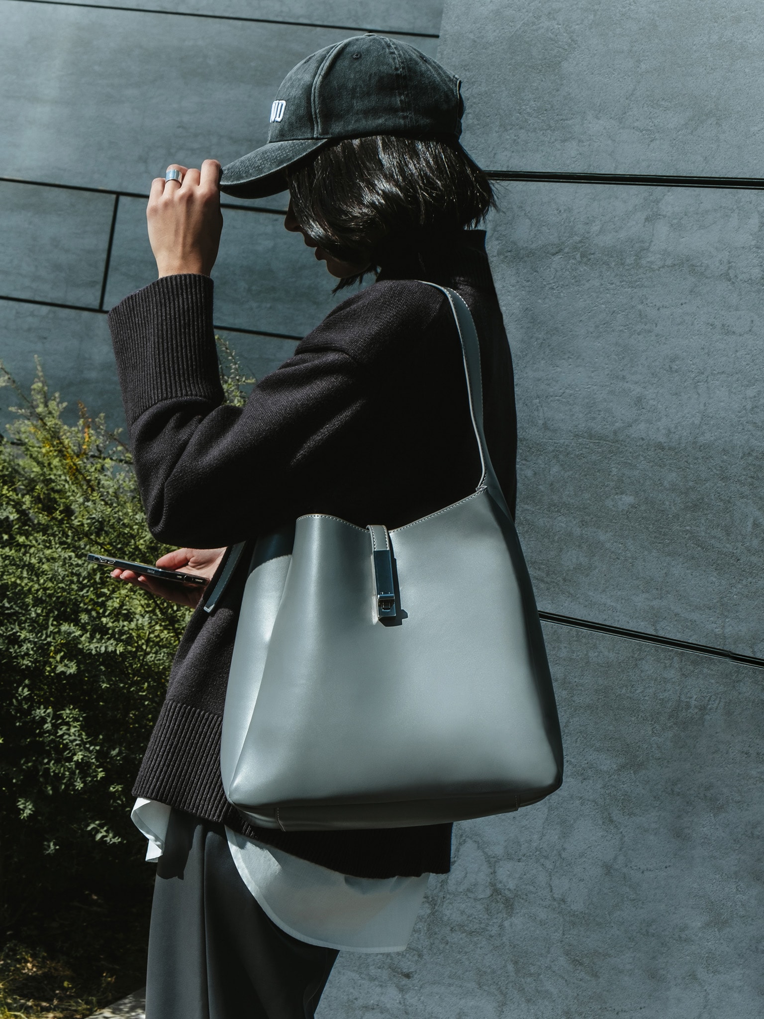 Square hard bag with a wide shoulder strap