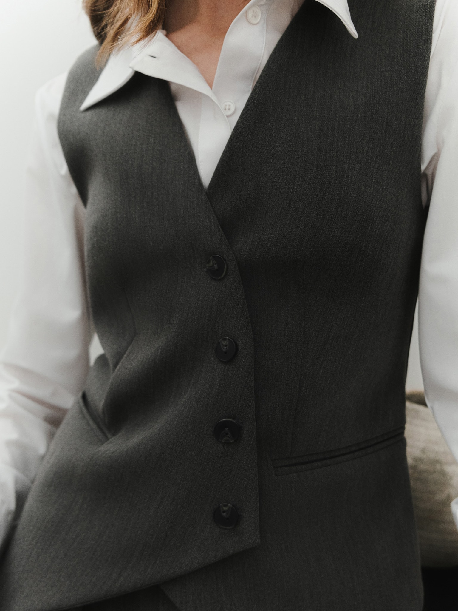 Vest with asymmetrical buttons in suiting fabric
