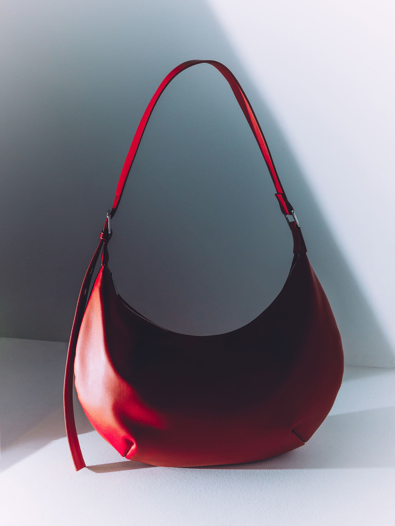 Semi-circular eco-leather bag with wide strap