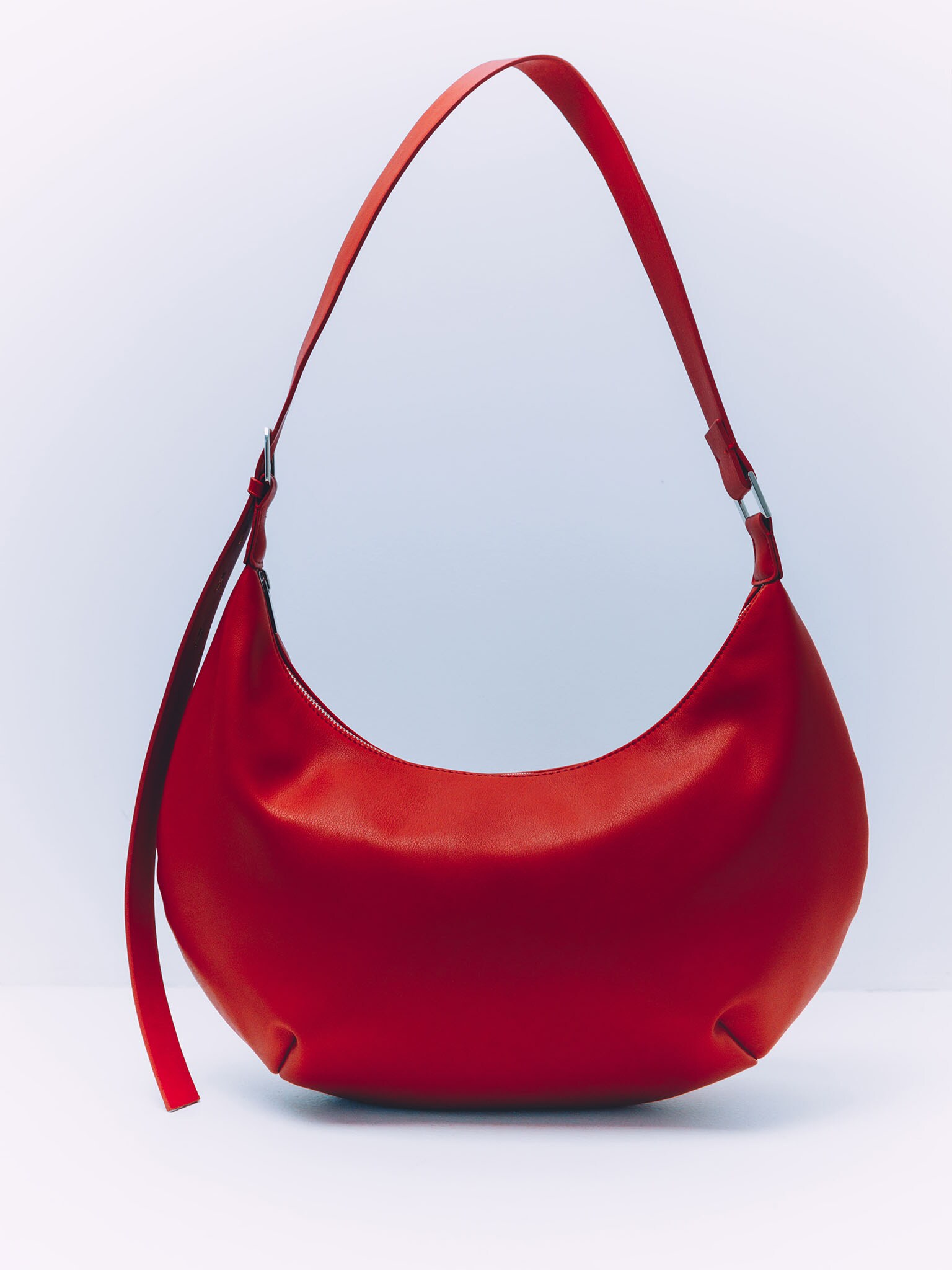 Semi-circular eco-leather bag with wide strap