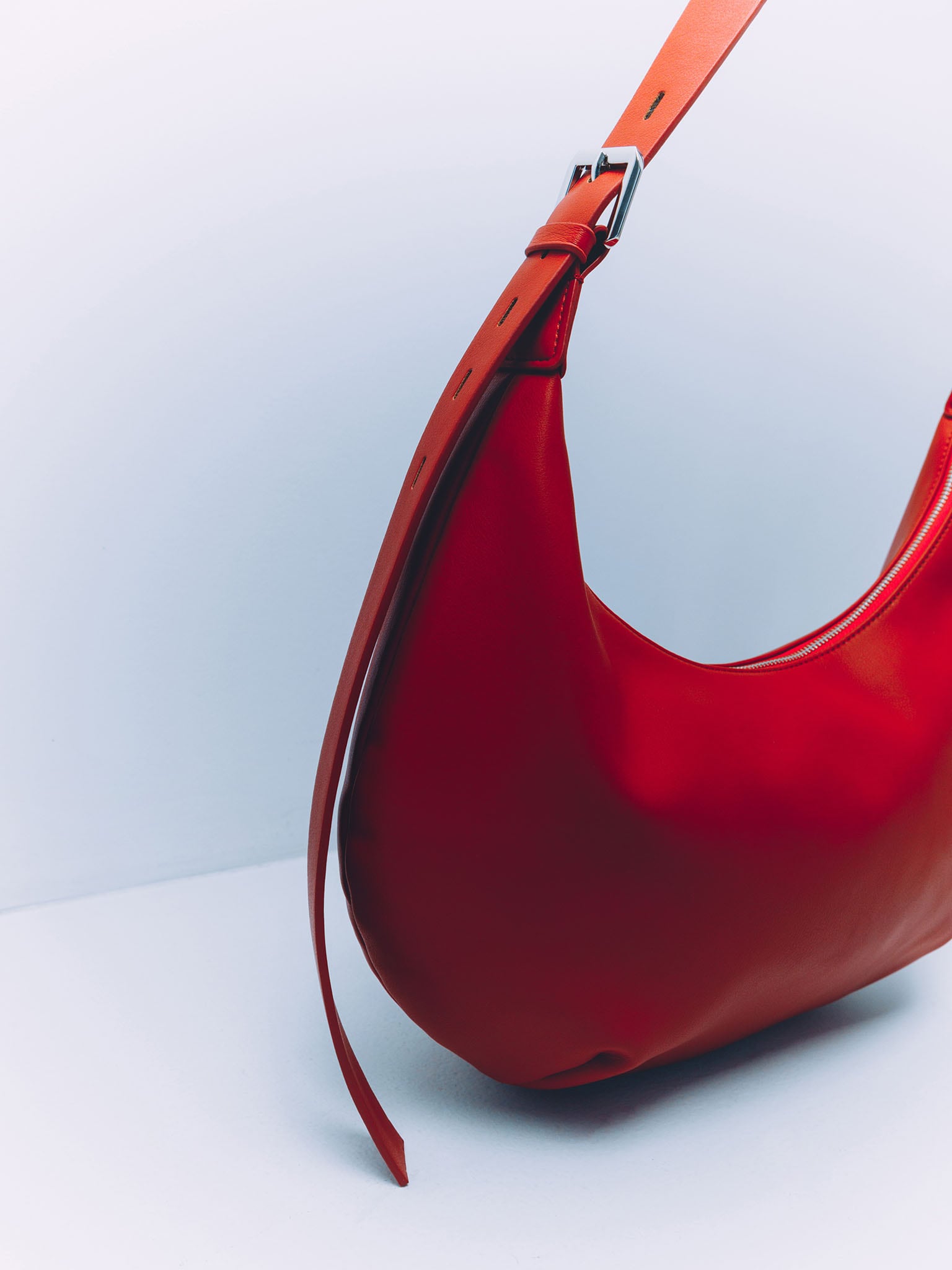 Semi-circular eco-leather bag with wide strap