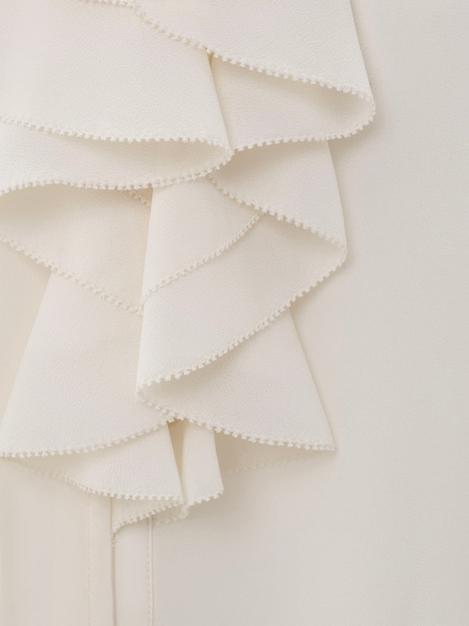 Light blouse with flounces and ties at the collar