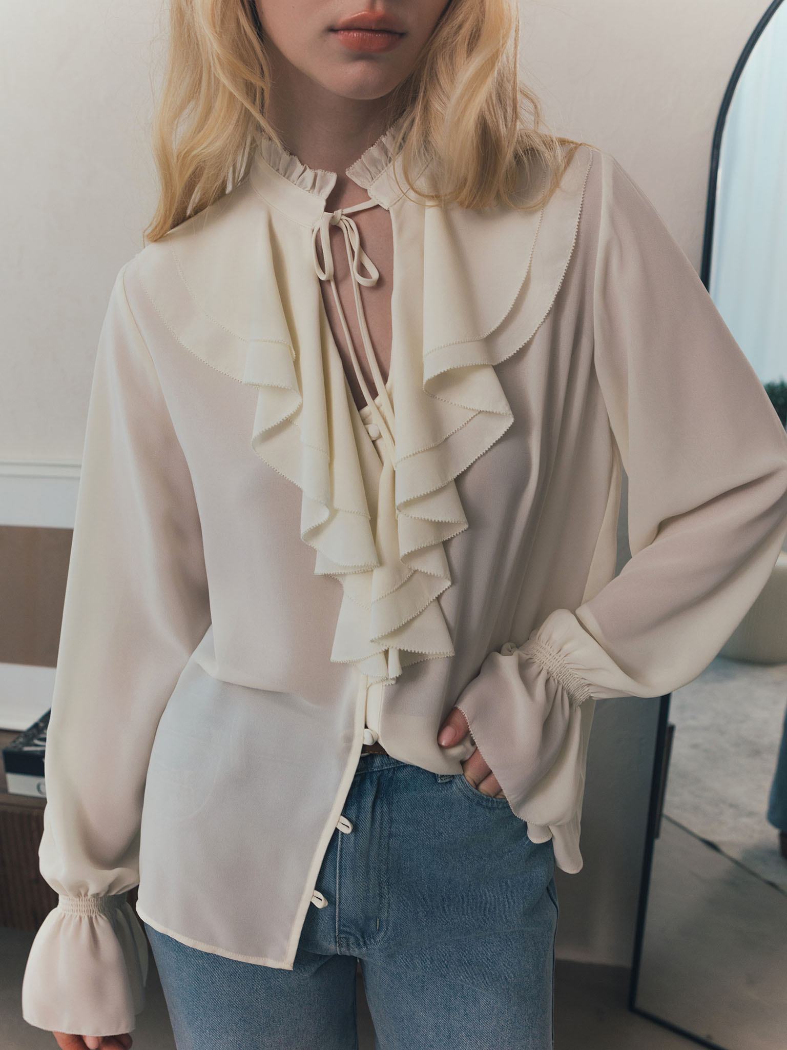 Light blouse with flounces and ties at the collar