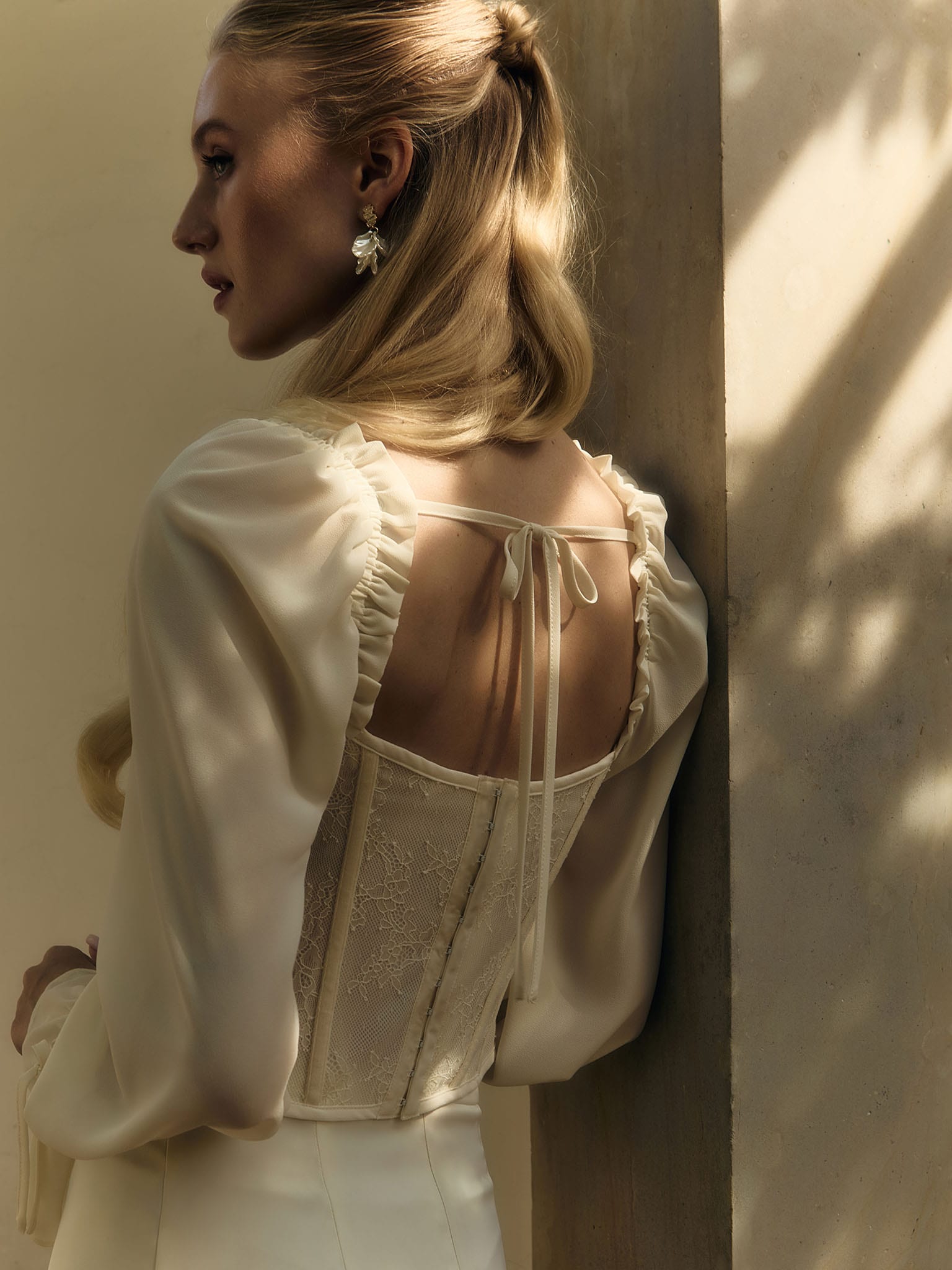 Corset blouse with lace waistband and tie-up cuffs
