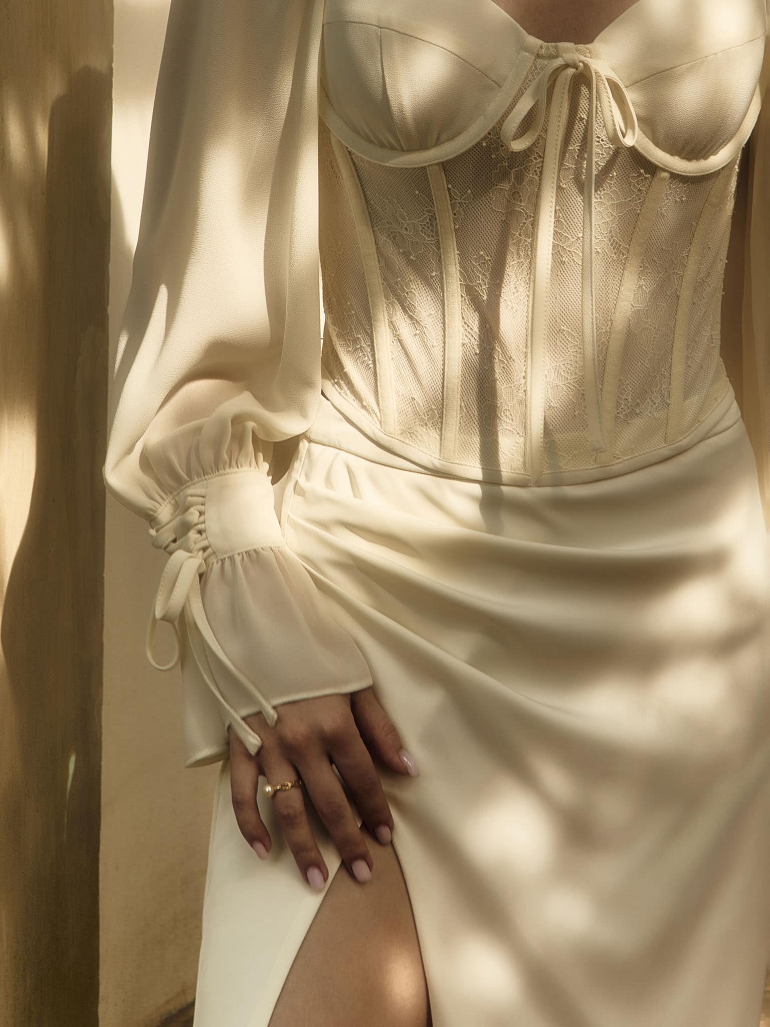 Corset blouse with lace waistband and tie-up cuffs