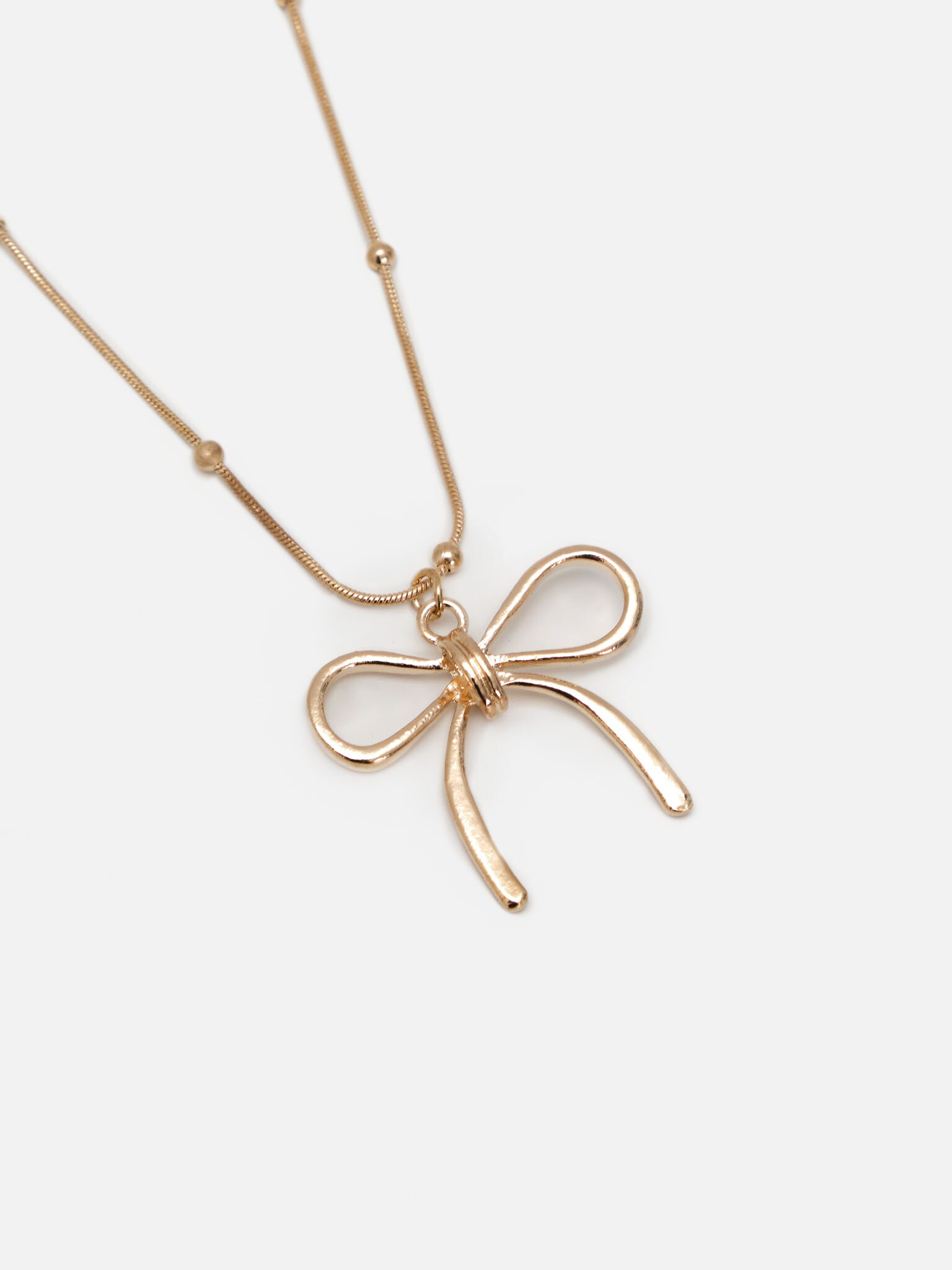 Golden chain with matching bow pendant
