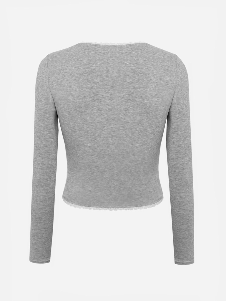 Jersey knitted longsleeve with openwork and bow on collar