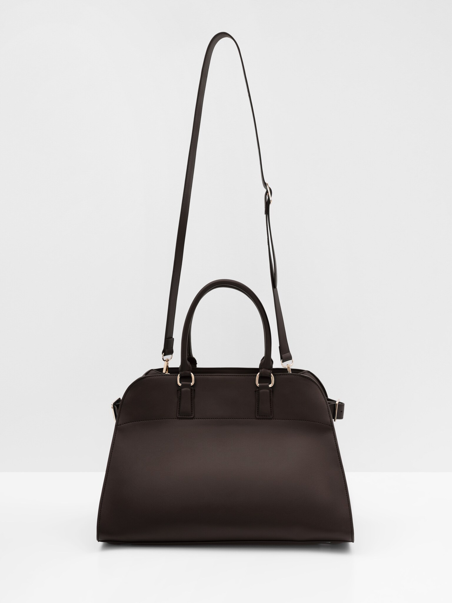 Трапециевидная сумка жесткой формы с ремешками по бокам