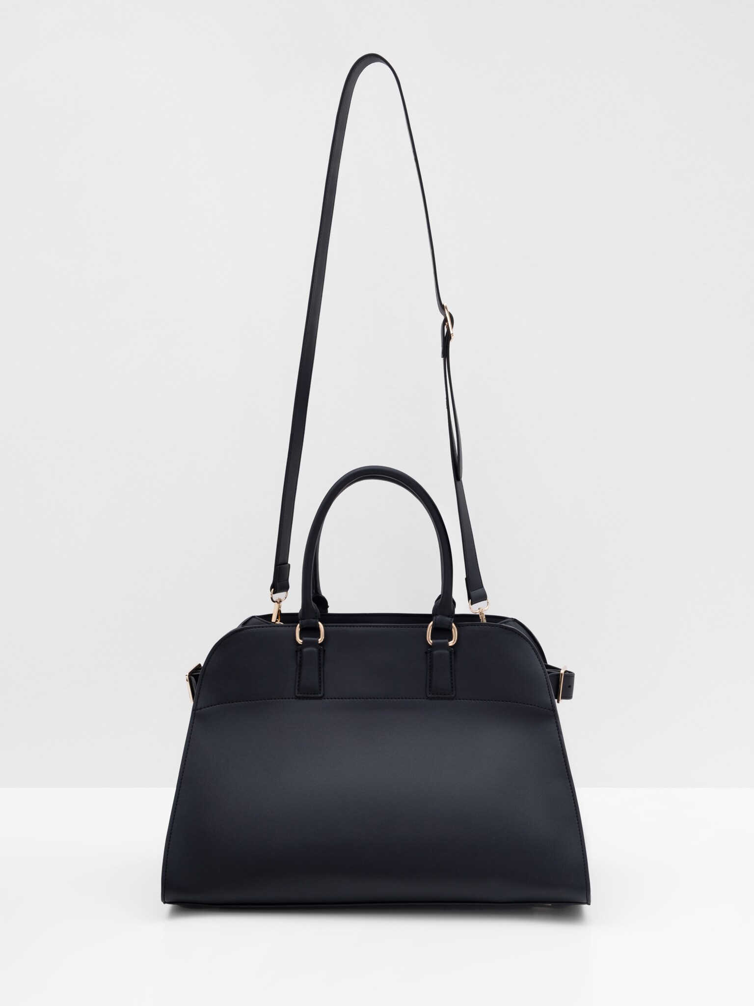 Трапециевидная сумка жесткой формы с ремешками по бокам