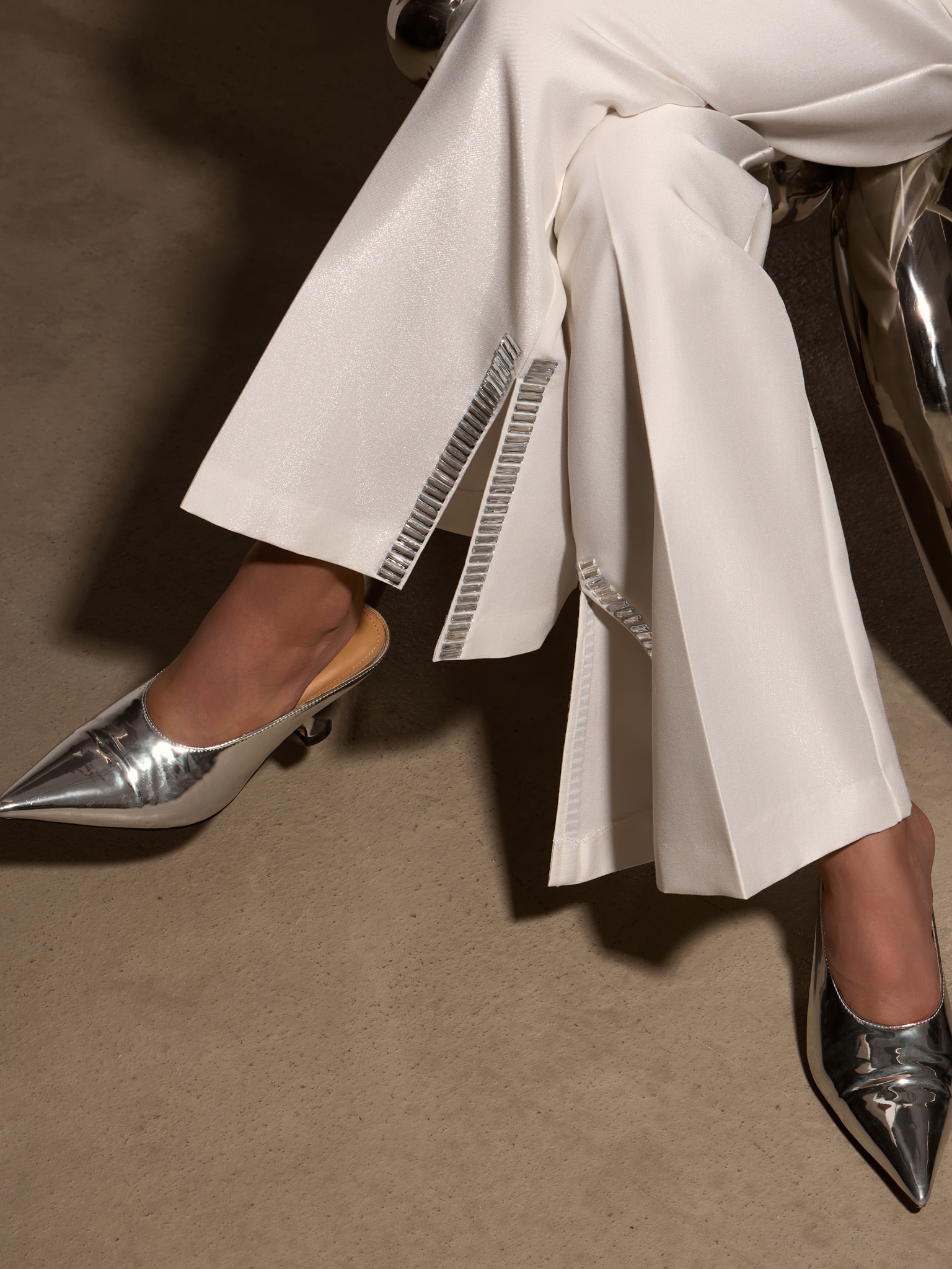 Trousers with slits on the pant legs and silvertone decor