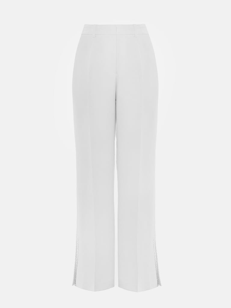 Pantalon avec fentes sur les jambes et décorations argentées