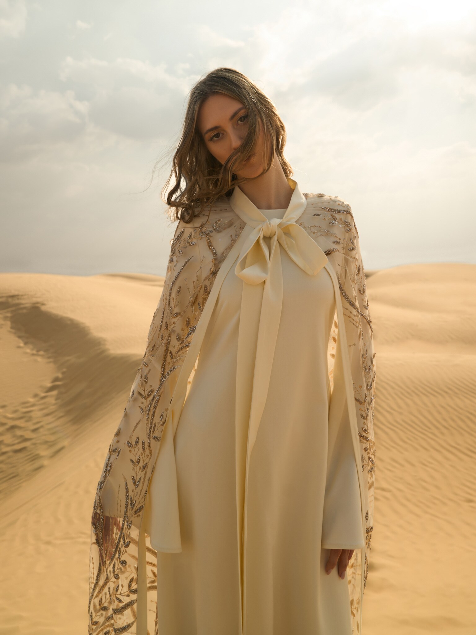 Translucent floor-length cape with glittering pattern