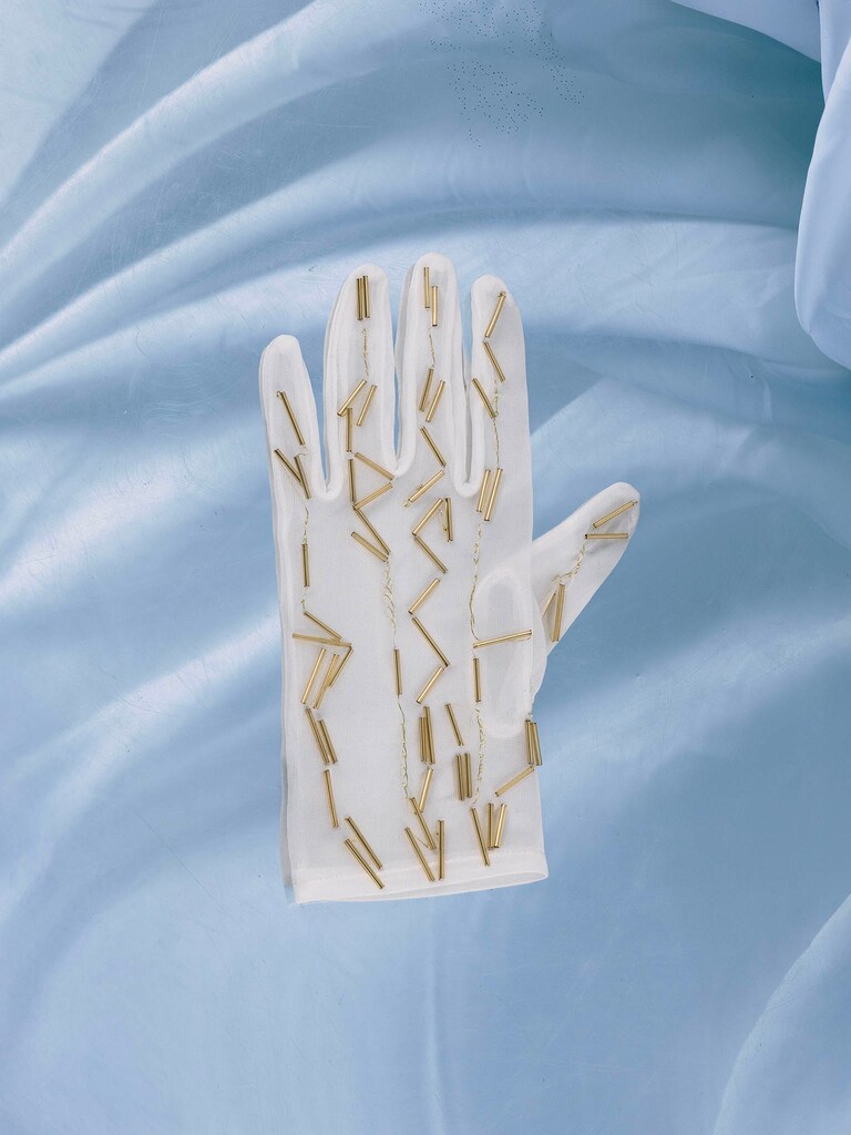 Semi-transparent gloves with golden decorations