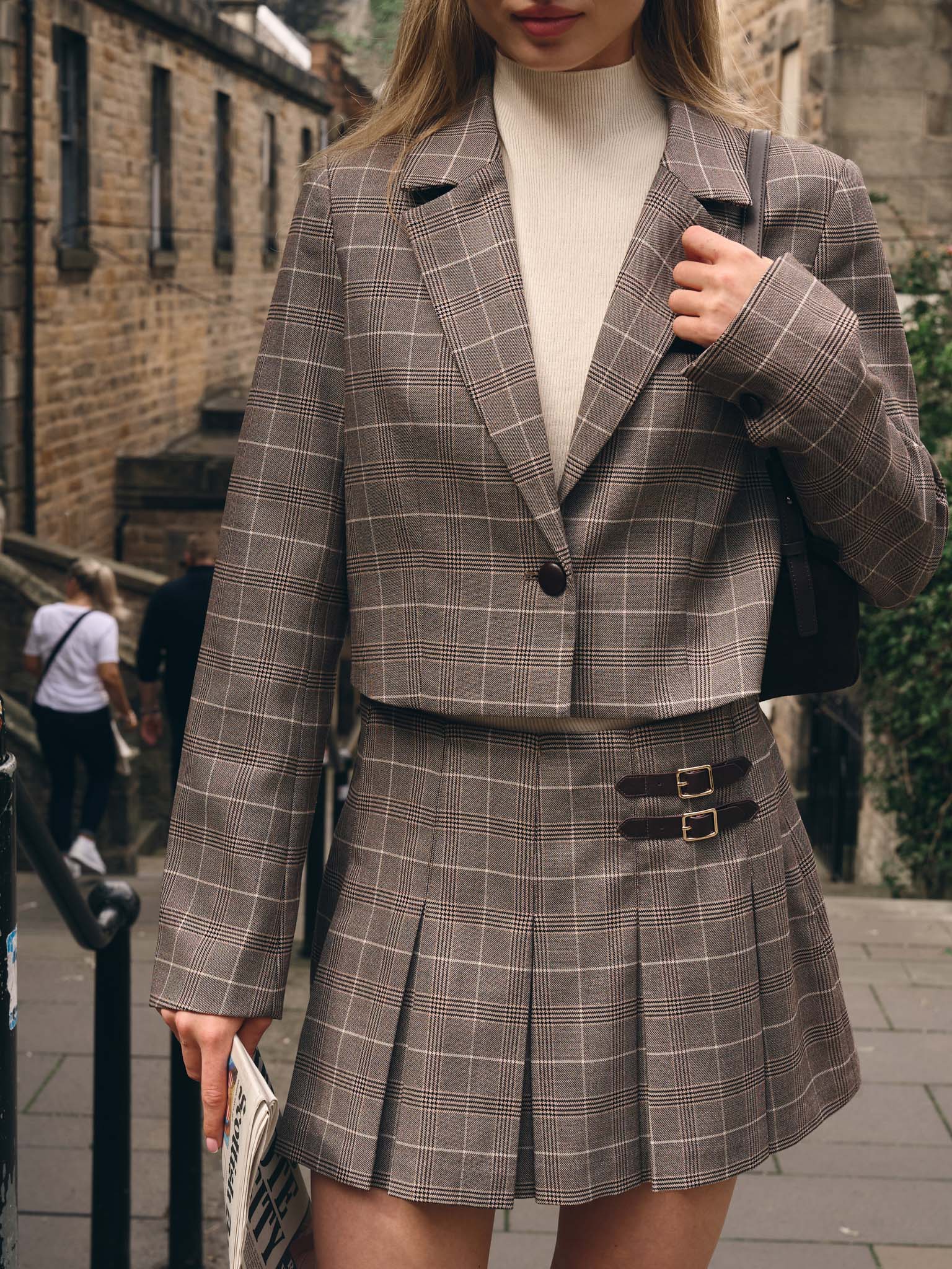 Mini pleated skirt with decorative straps