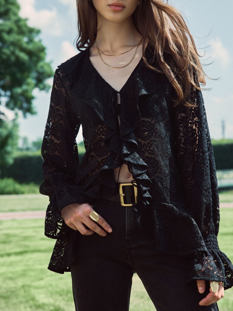 Openwork blouse with voluminous flounces on the collar