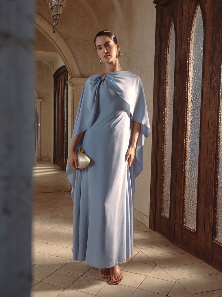 Maxi dress with train and metal decor on the shoulder