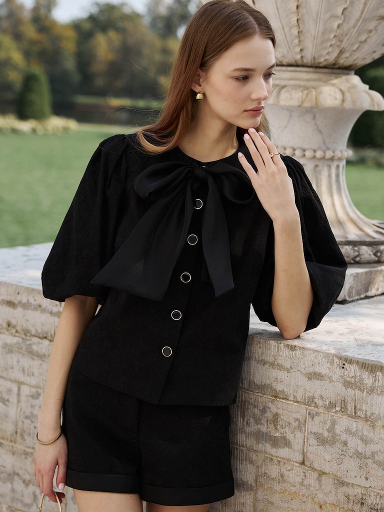 Textured blouse with a voluminous bow