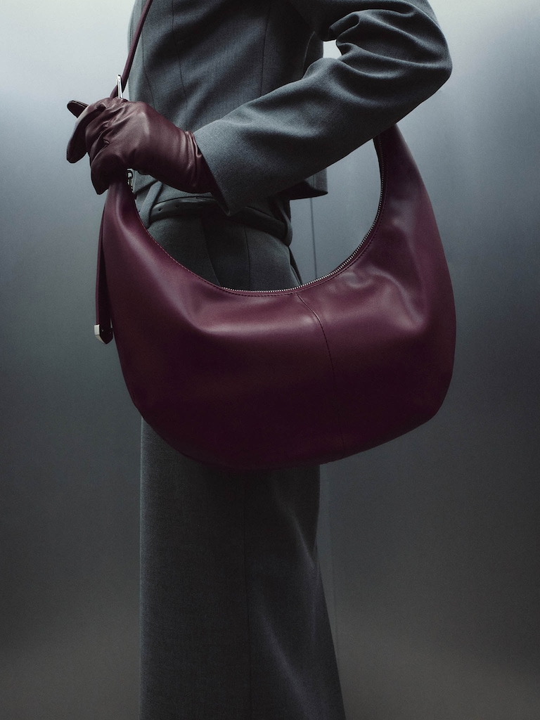 Semi-circular bag with long shoulder strap