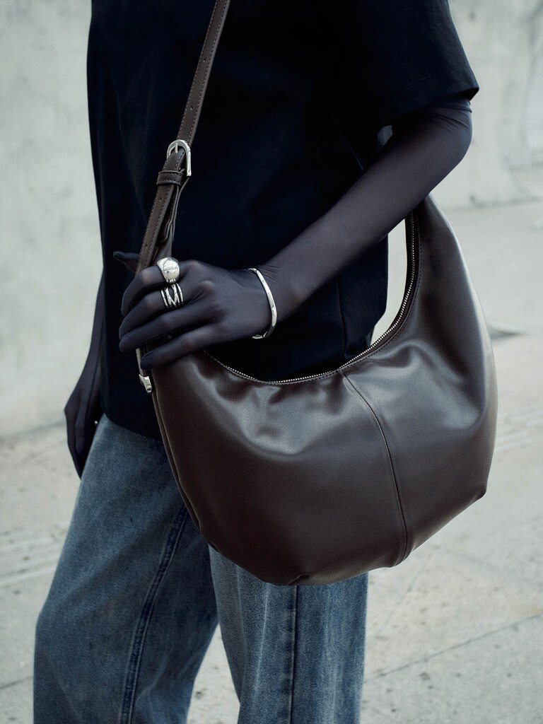 Semi-circular bag with long shoulder strap