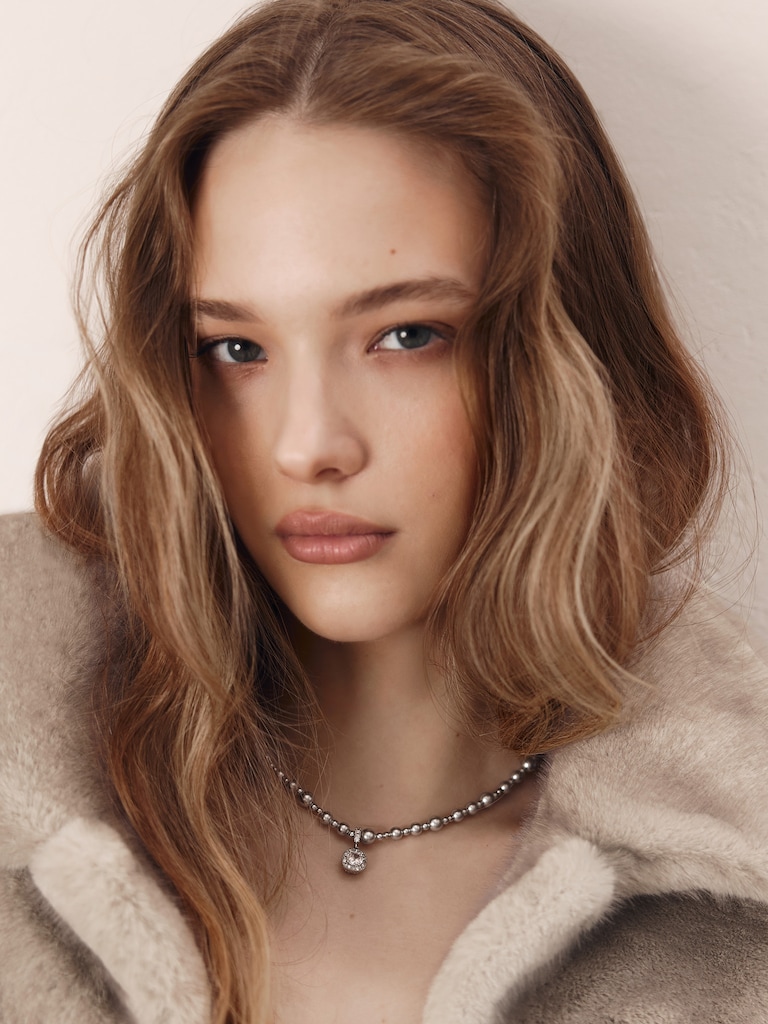 Silvertone bead necklace with a rhinestone pendant