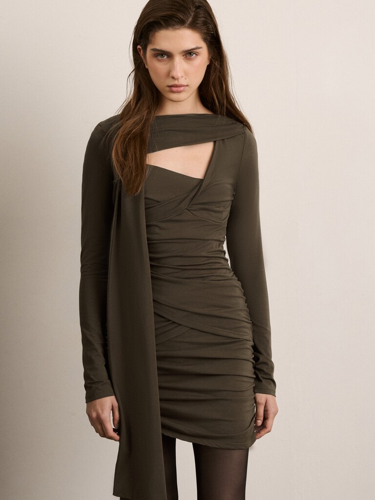 Knitted mini dress with asymmetrical pleats and decorative scarf