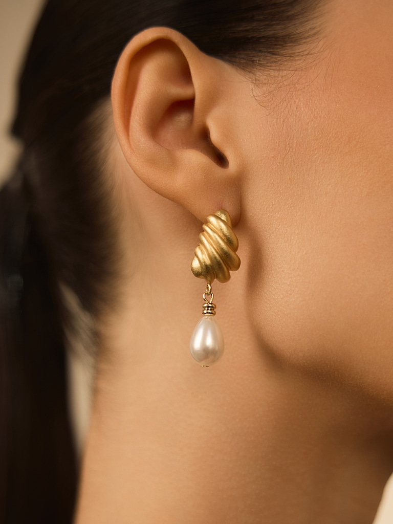 Stud earrings with intricate designs and teardrop pendants