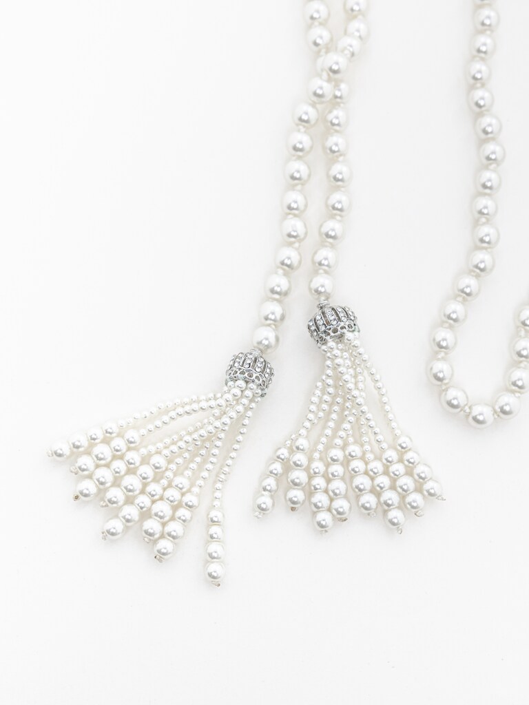 Long pearl strand with pendants at the ends