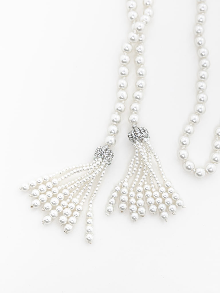 Long pearl strand with pendants at the ends