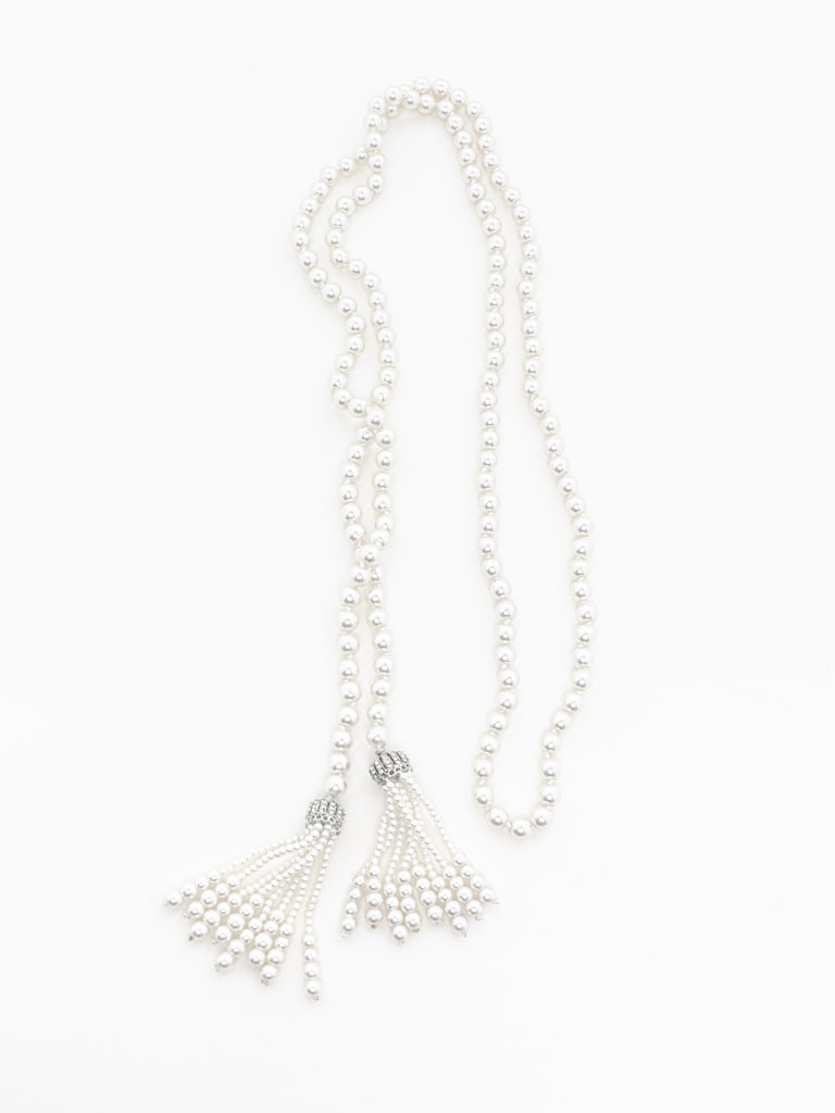 Long pearl strand with pendants at the ends