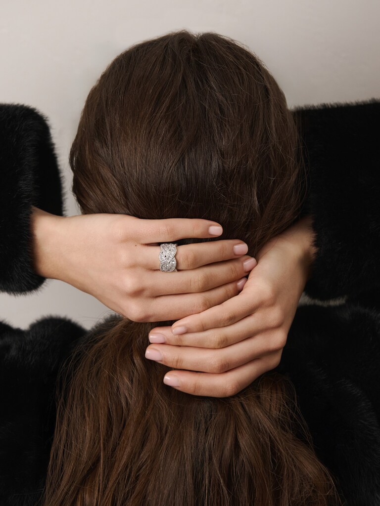 Ring with braided design and crystal decoration