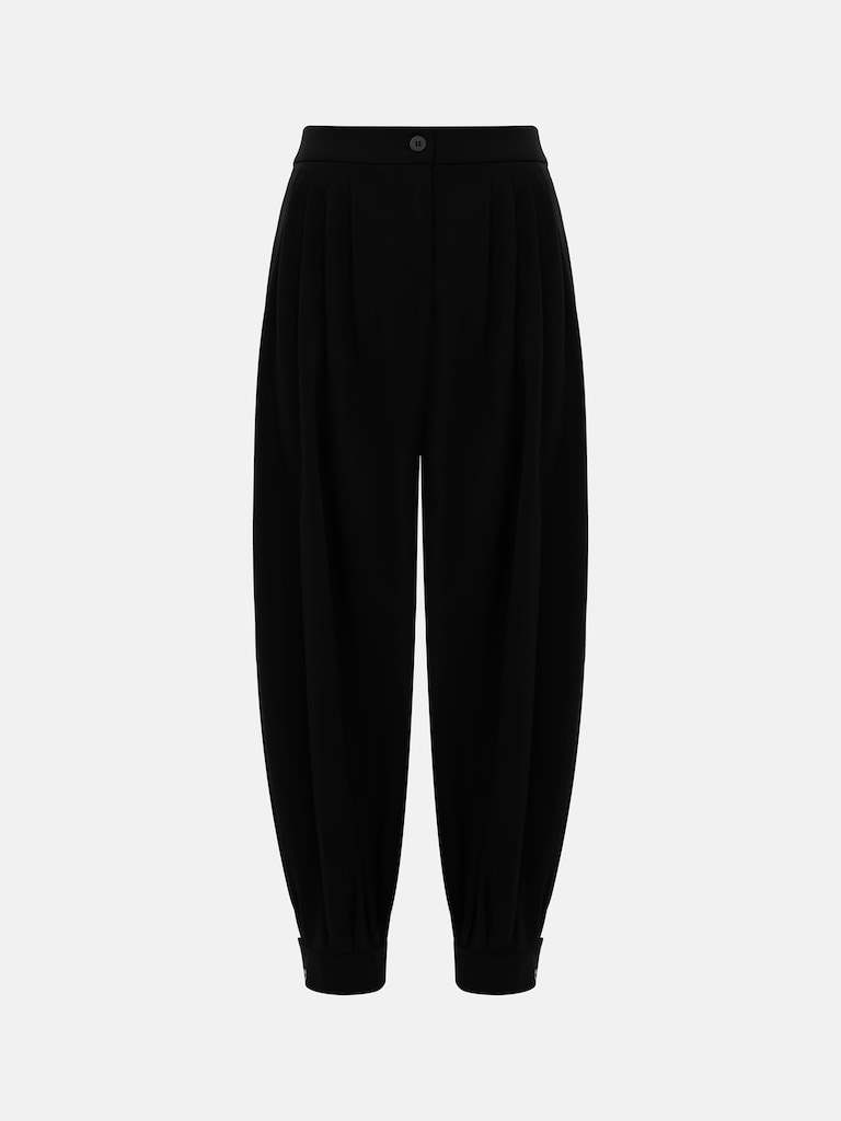 Свободные брюки с защипами на талии и прилегающими манжетами